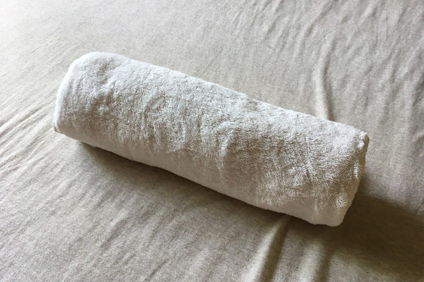Rolled towel pillow